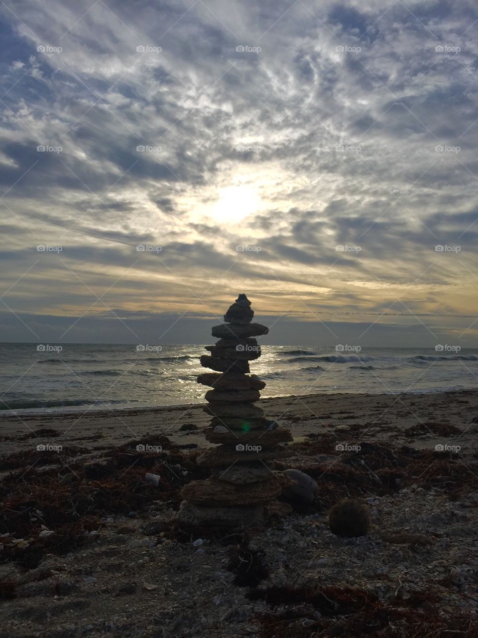 Cairn. Stormy sky. Silhouette. Magic. Seascape