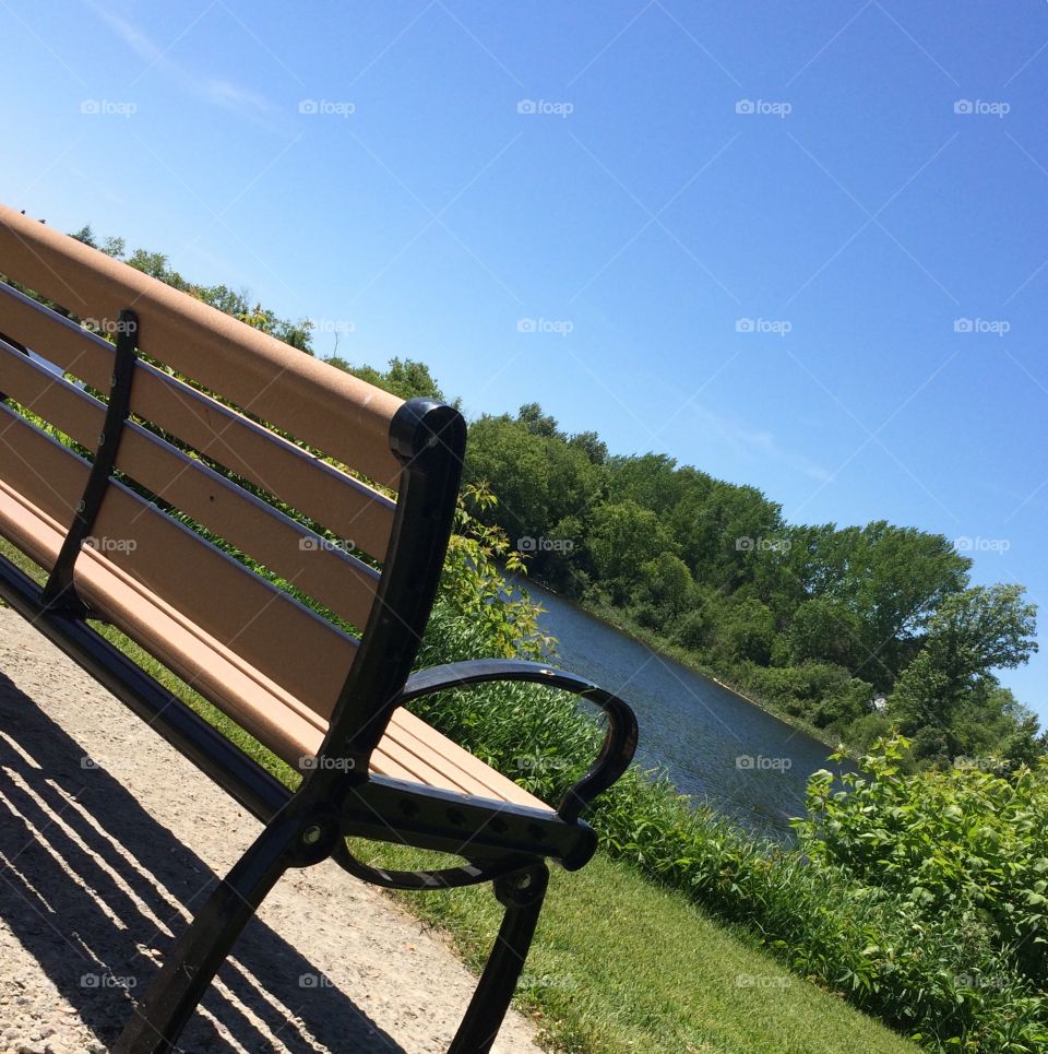What a beautiful nice day bench near the water