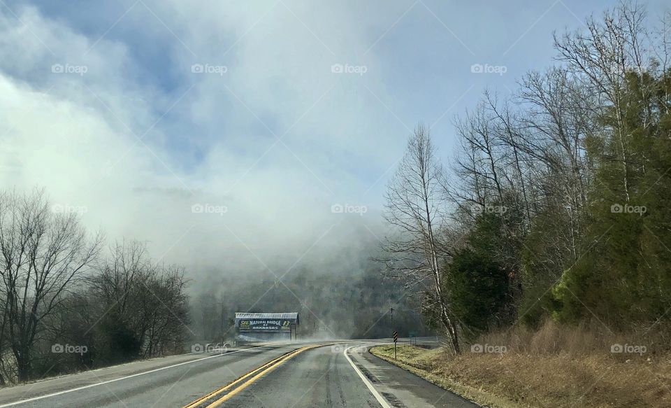 A haunting stretch of highway through the foothills of Arkansas as mist rises in the February air.