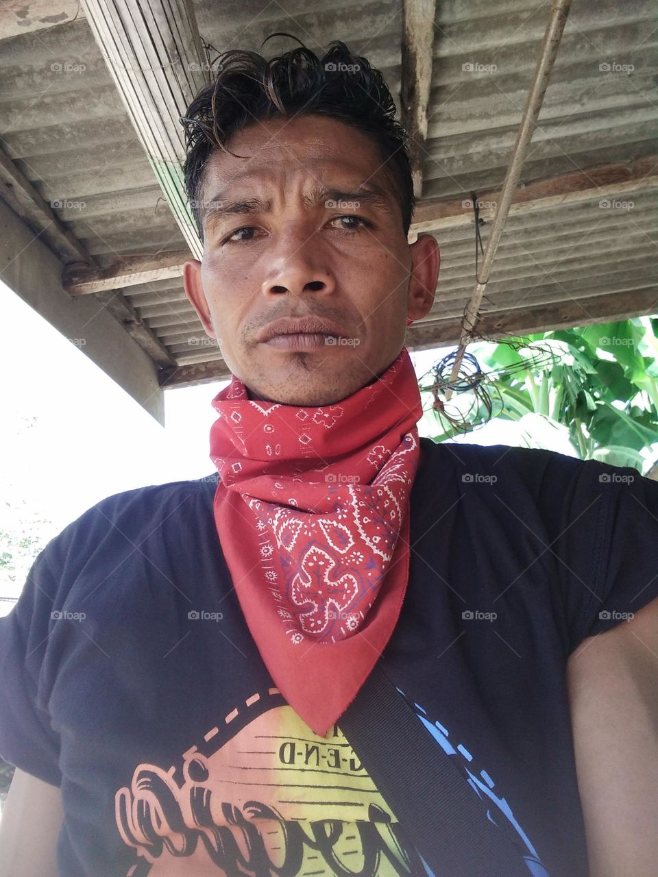 a man is standing outside the house, taking a photo with a camera