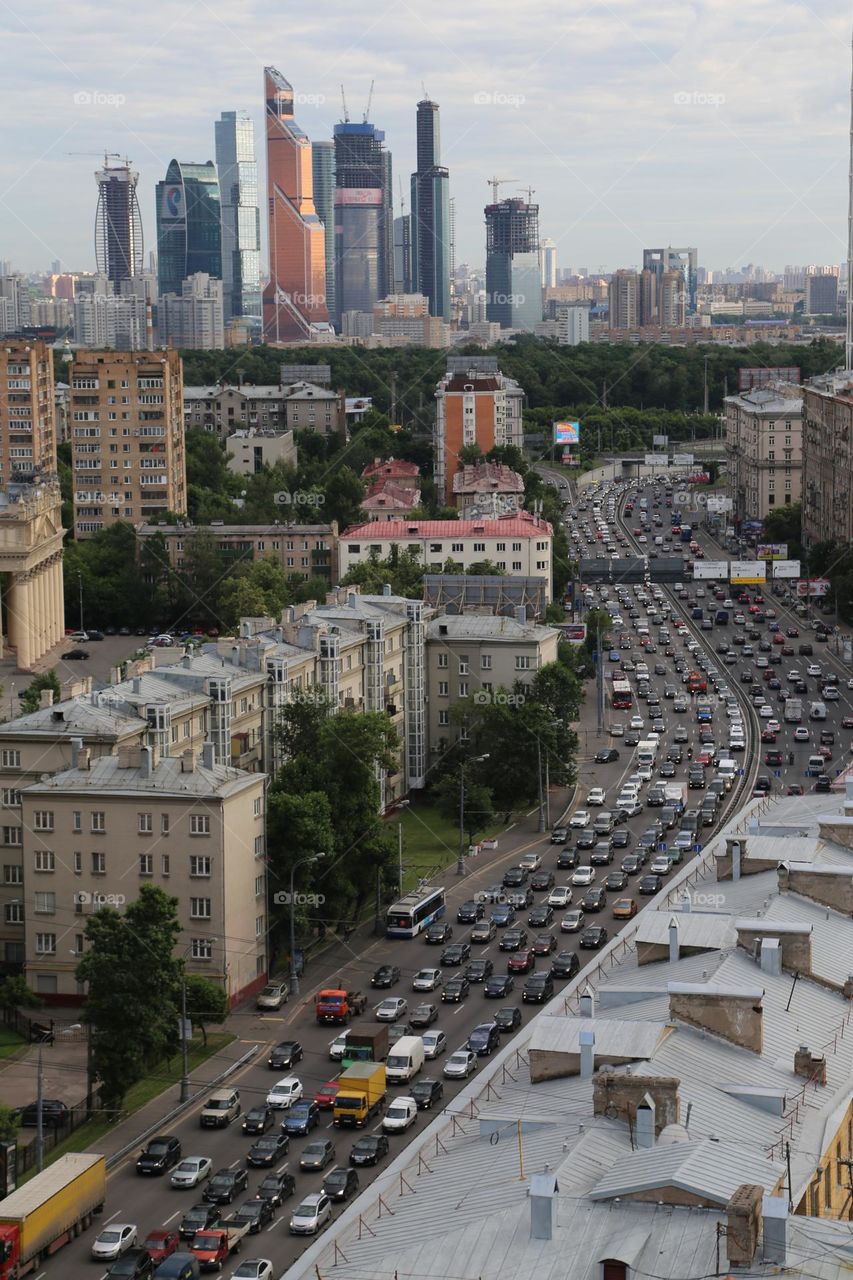 Busy car traffic to & from a business district with skyscrapers