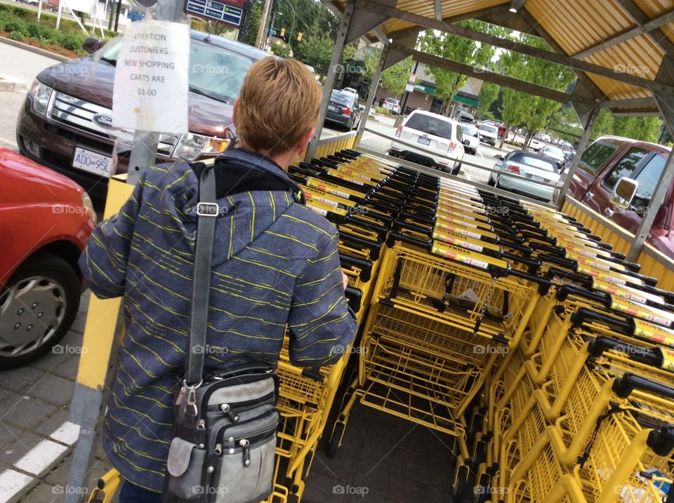 Yellow shopping carts. Colourful shopping carts in an outdoor parking lot