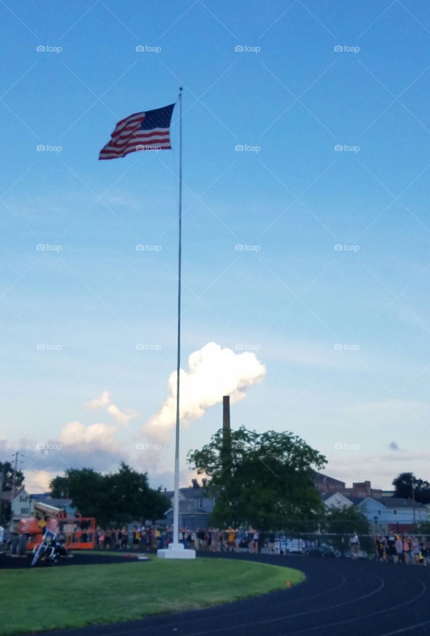 The cloud looks like smoke coming out of the smoke stack