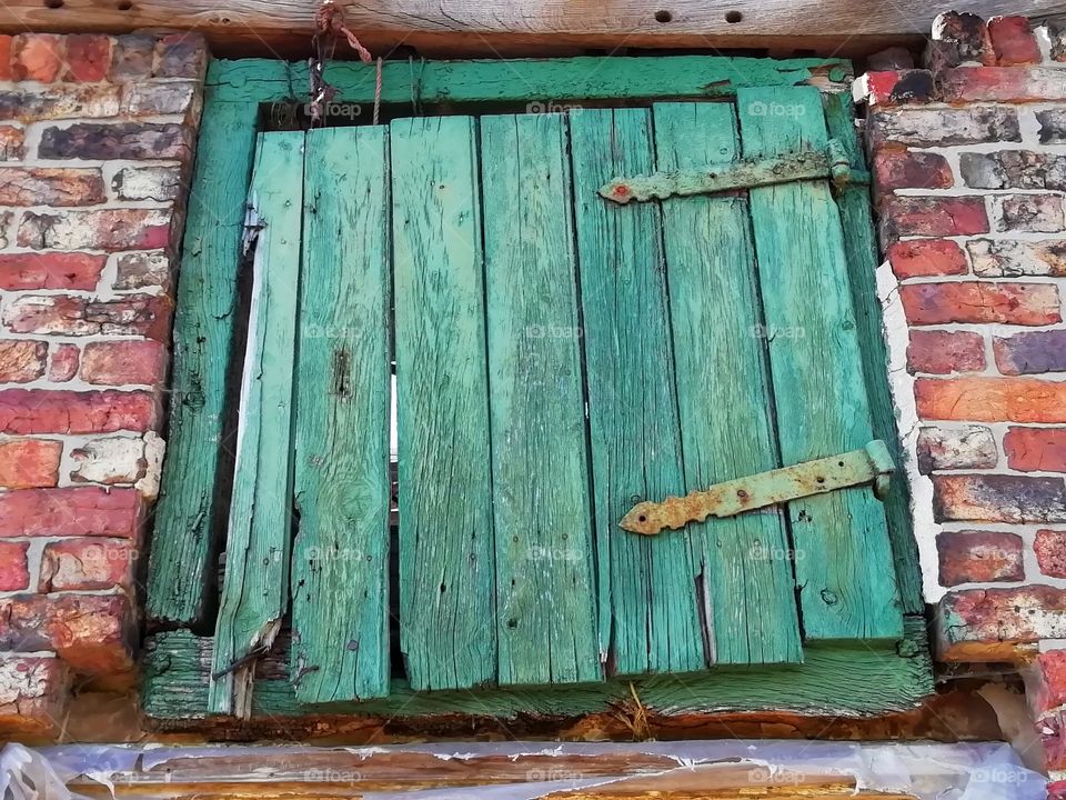 Green wooden window shutter