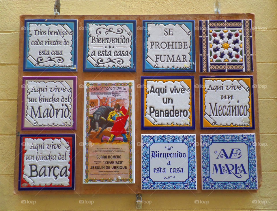 Decorative Tiles Hanging on the Yellow Wall in Seville, Spain