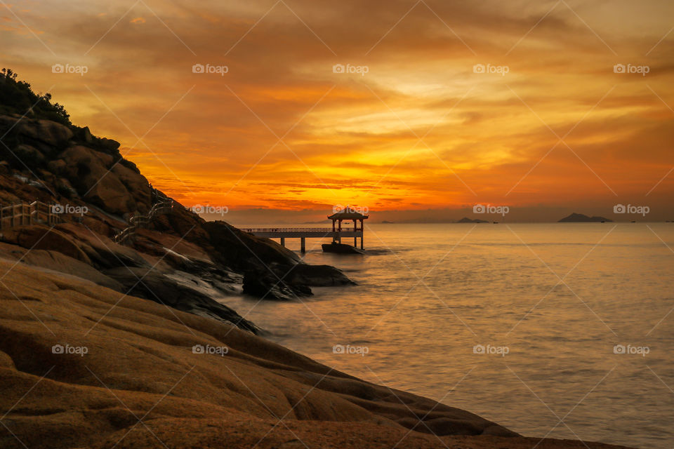 One of my unforgettable shot during my Visit at Long Chao Kok coastal trail, a beautiful sunrise Dawn Color at the Horizon reflecting on the water through the Coastline.