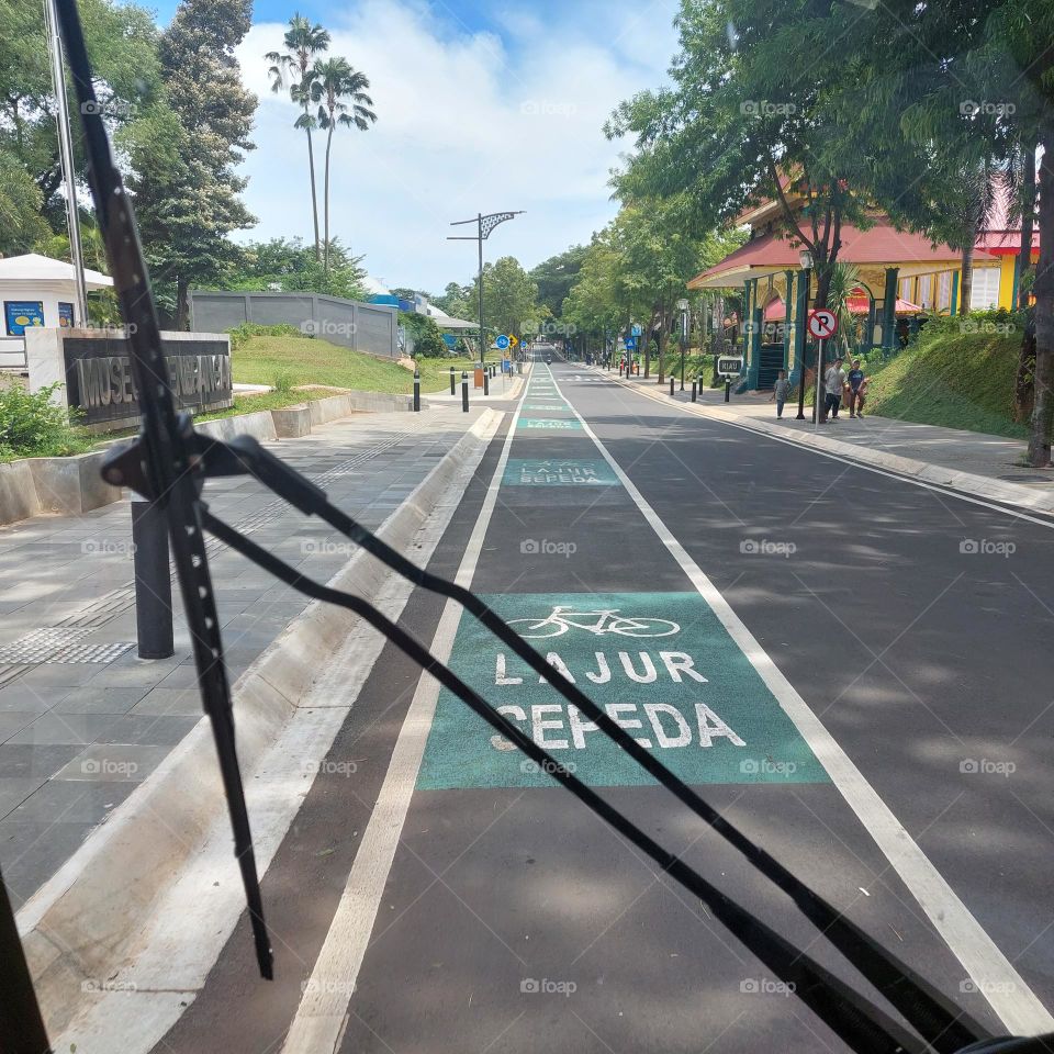 traveling by electric vehicle on empty streets with bicycle lanes on the side