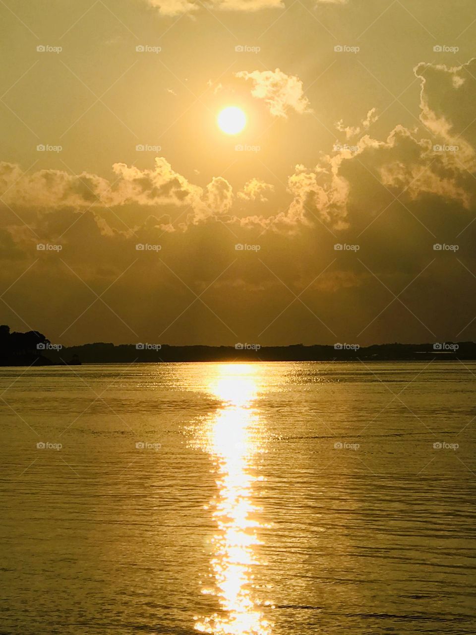 Sunset over the lake, serene and golden. 