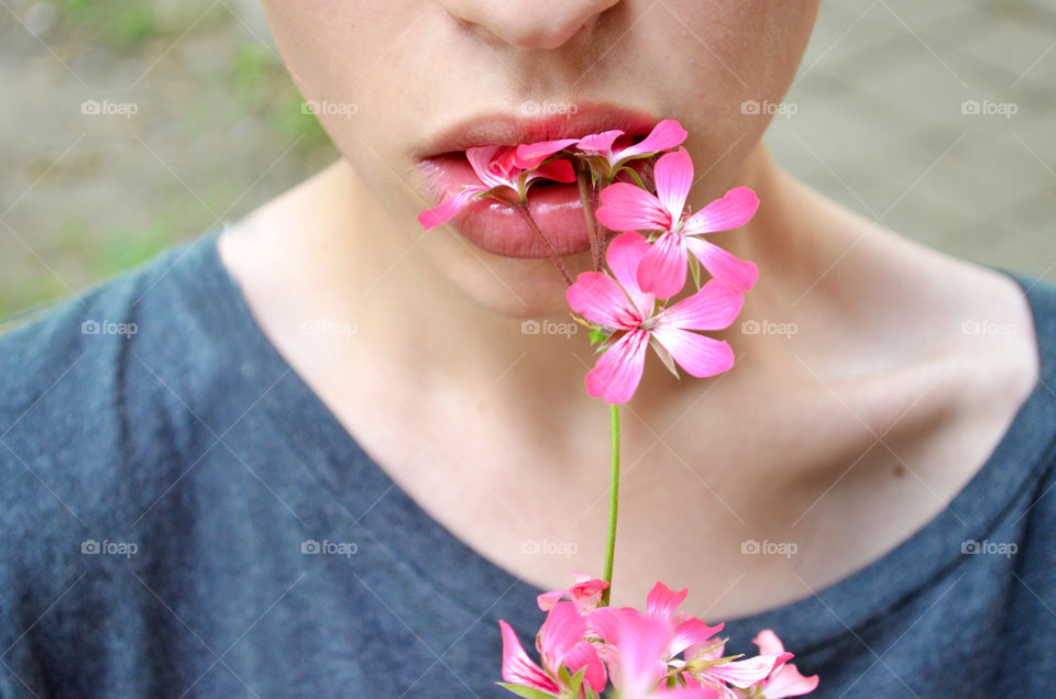 Close-up of boy eating pink flower