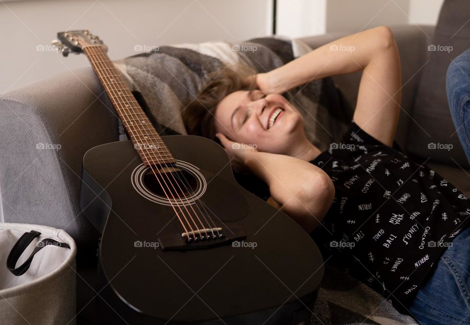 Happy woman with a guitar 