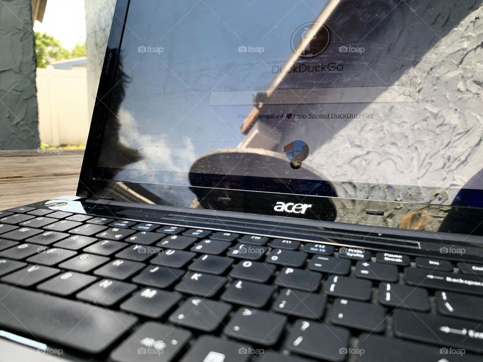 Working Online On The Laptop Writing Down A Start Of A Search On A Searching Engine Outside With Sky Reflection