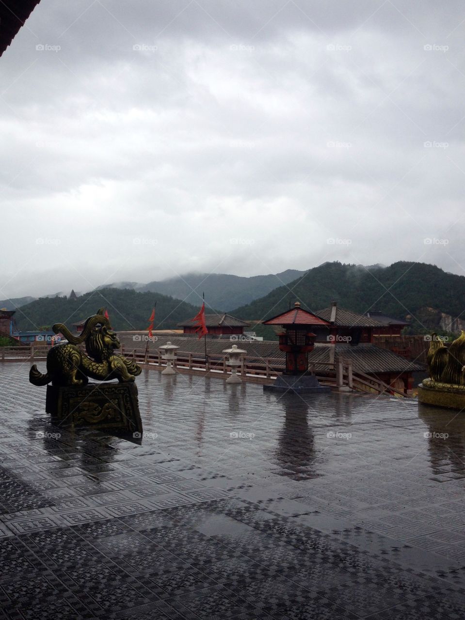 Traditional Chinese architecture and mountain view on a rainy day