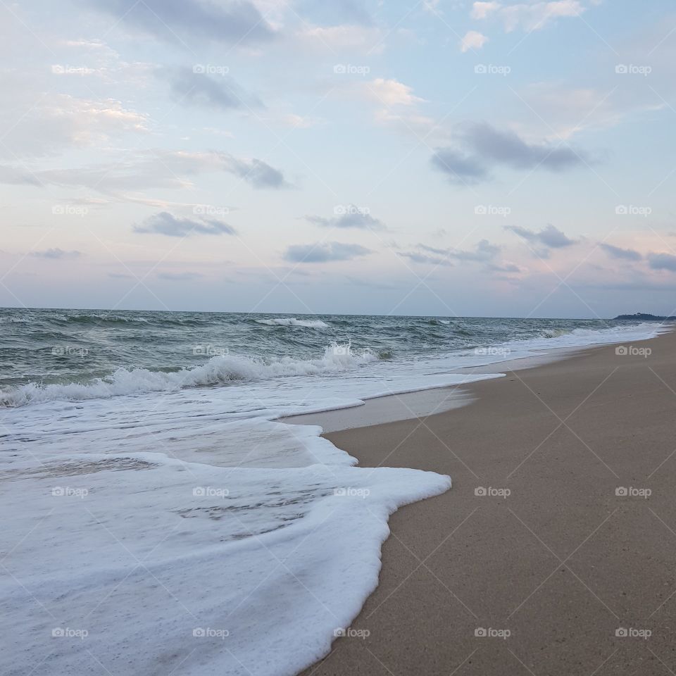 Scenic view of beach against pink sky