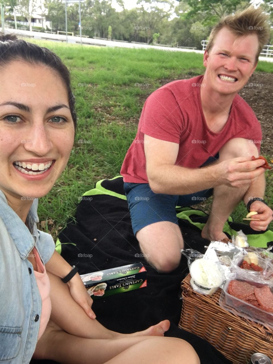 Portrait of couple eating in park