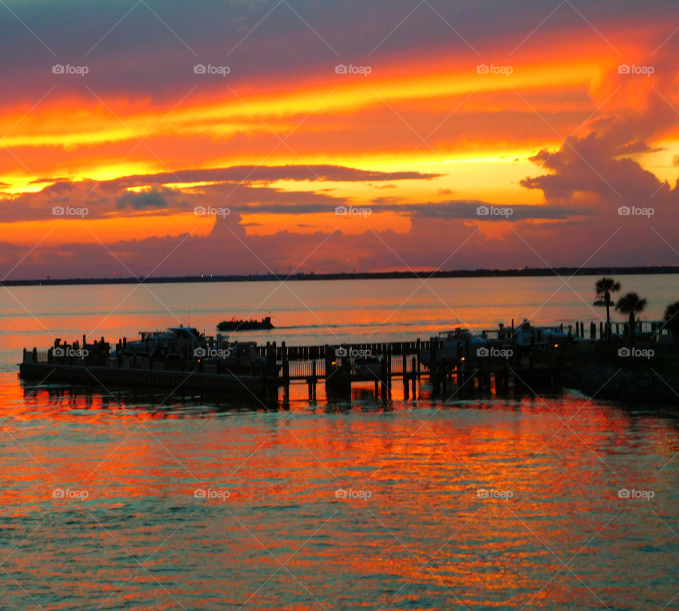 Clouds catch the last red-orange rays of the setting sun and the last light of dusk. The entire landscape takes a surreal saffron hue as the clouds reflect the fading sun!