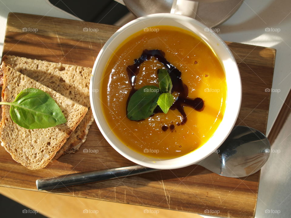 Delicious and hot pumpkin soup with bread