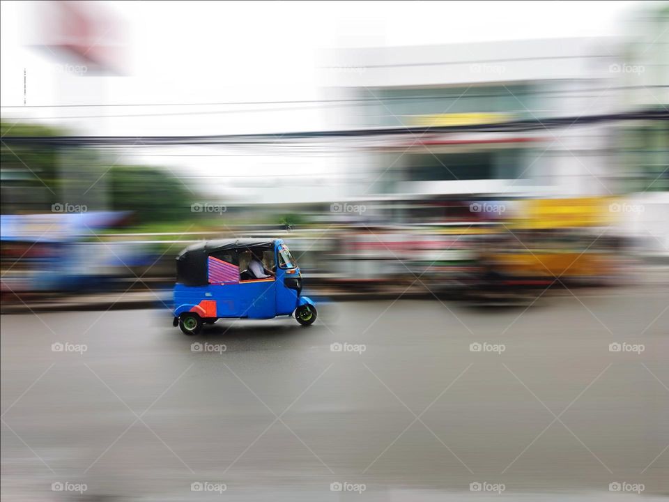 Bajaj.  Three-wheeled car driving on Jalan Kebayoran Lama, Jakarta.