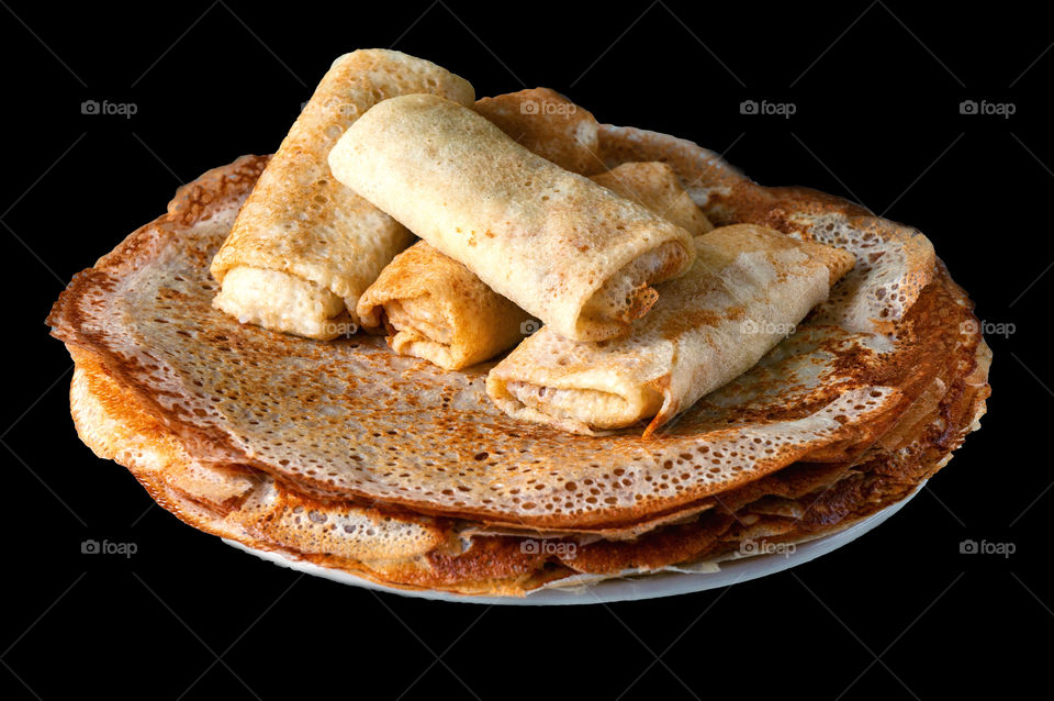 Golden pancakes on a black background. isolate pancakes. pancakes on a plate. delicious food. Breakfast dishes.