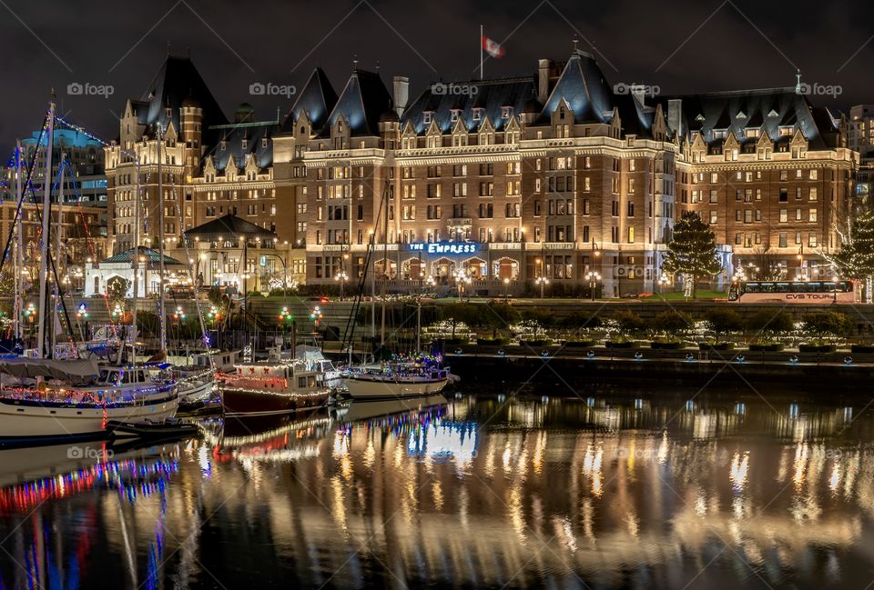 Downtown Victoria, Canada, and the harbour at night - with the famous Empress Hotel reflecting in the ocean water 