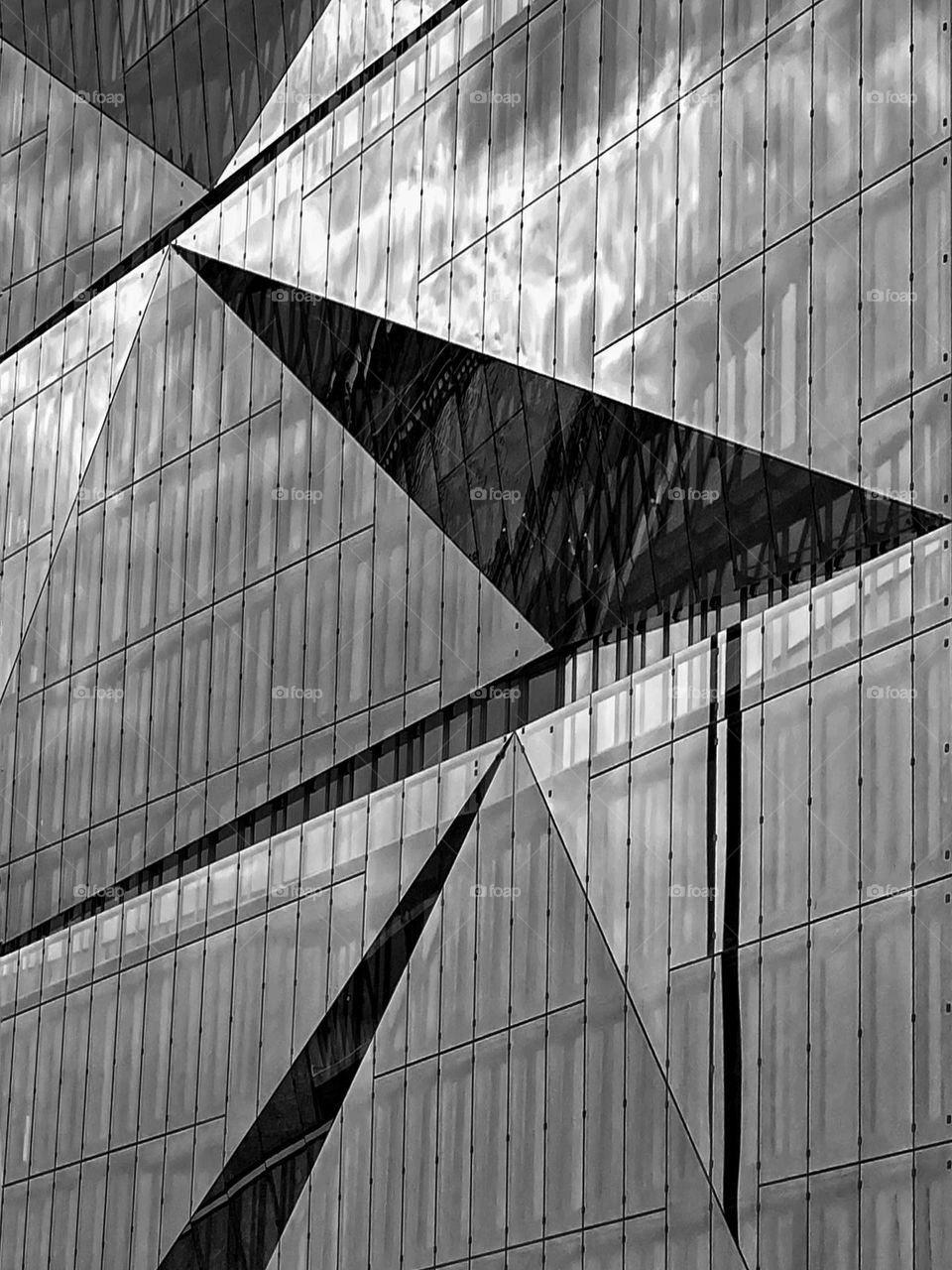 Black and white photo of a glass facade on a building