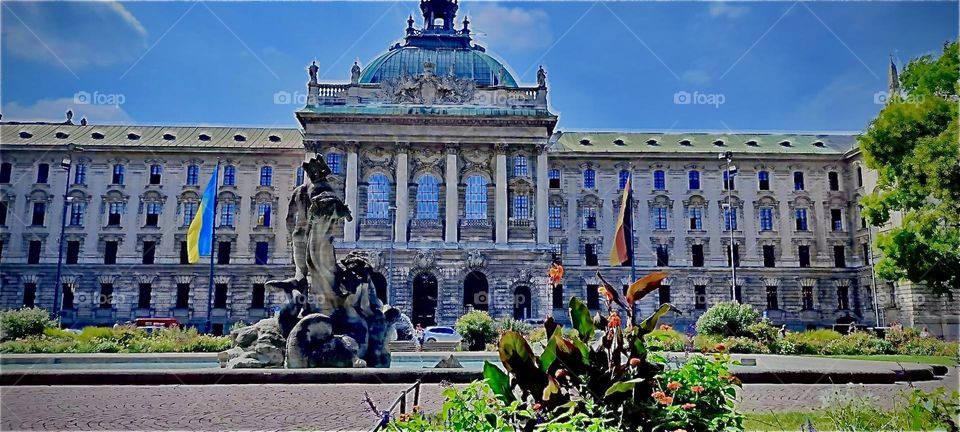 A nostalgic image from „Munich“, the old capitol of „Bavaria“ in the South of Germany. This magnificent and sheer majestic building with a fountain adorned with a sculpture up front is a feast for the eyes to behold. 2022. Hypnotic Productions