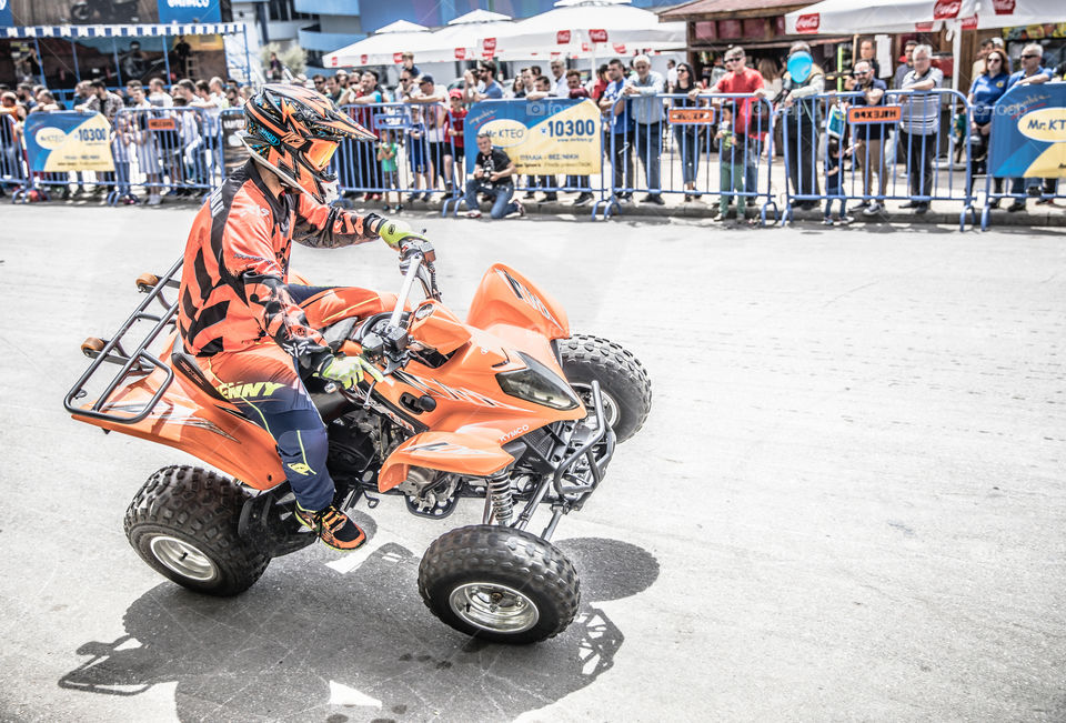 Doing Acrobatics With Quad Bike Terrain Vehicle In Front Of Crowd
