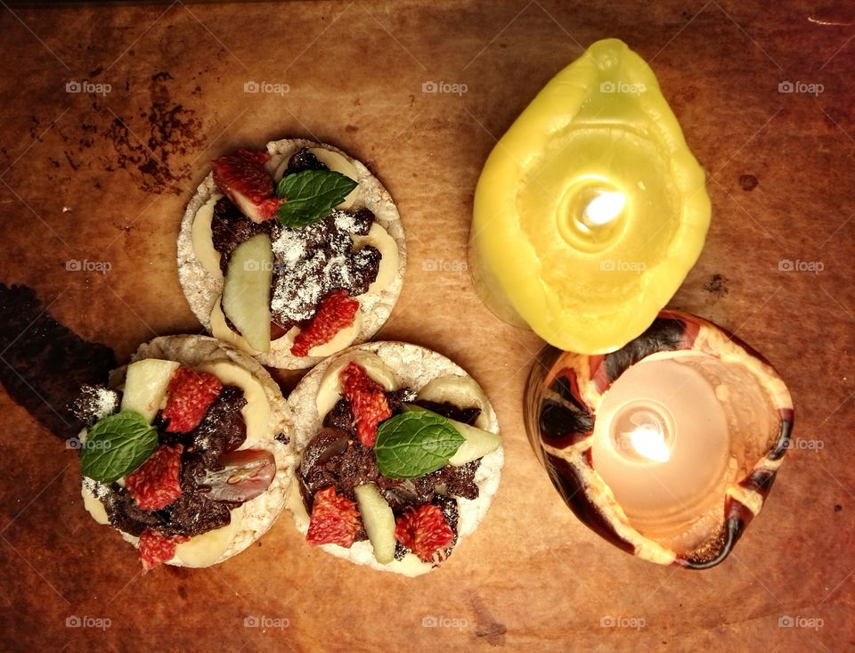 Healthy sweets with fruits and dark chocolate on a rustic background