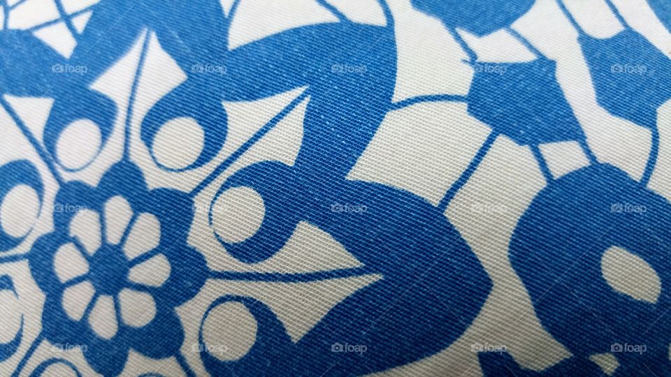 worn patterned fabric, blue and white, macro shot