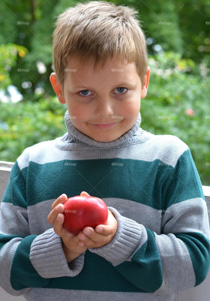 child and red apple portrait green background