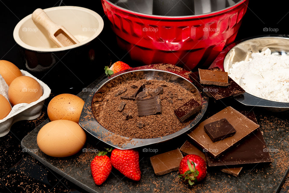 ingredients for chocolate cake and a cake tin