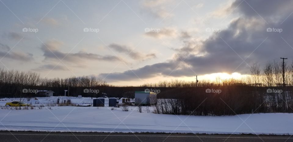 sun set over an old gas station in rural canada