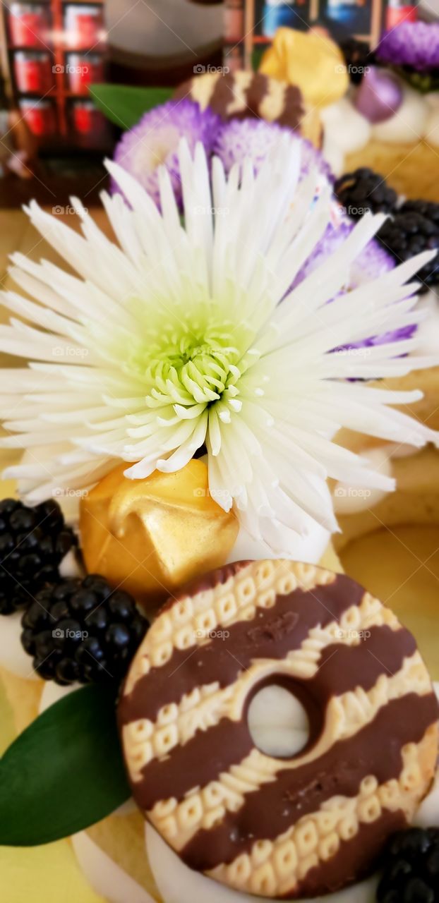 cake, fruit, meringue, cookies and fresh flowers