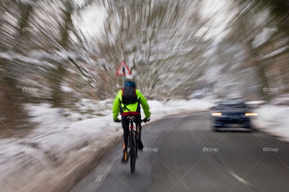 A cyclist on a snowy road.