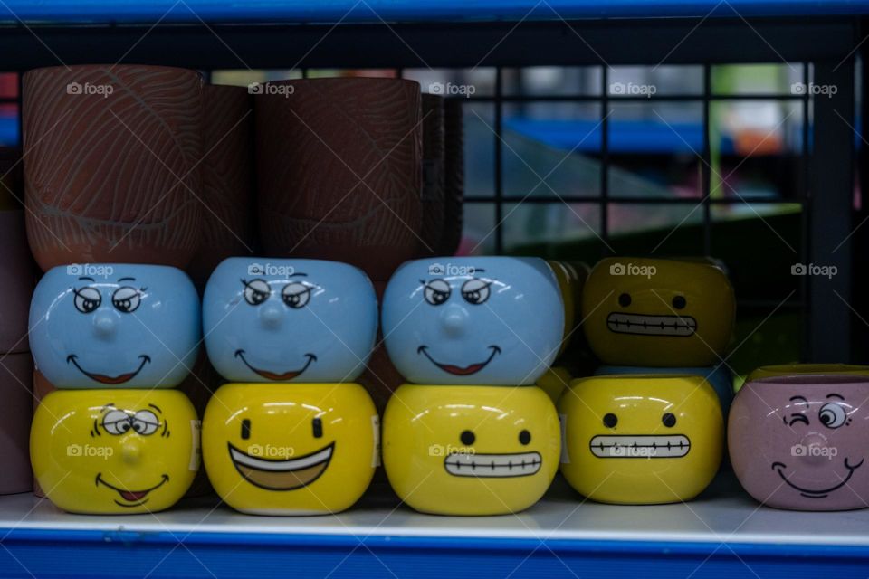 blue and yellow character glasses arranged on a shelf