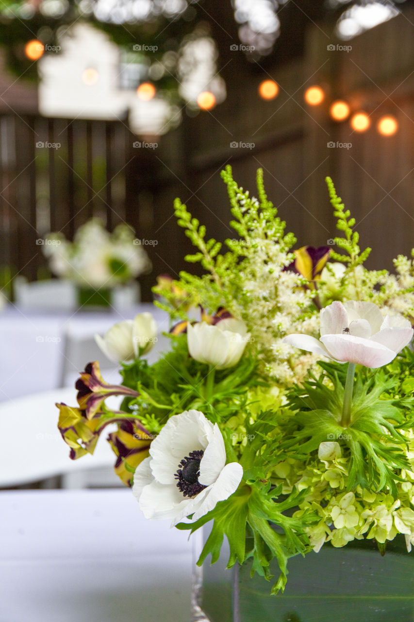 A white floral arrangement on a white table cloth