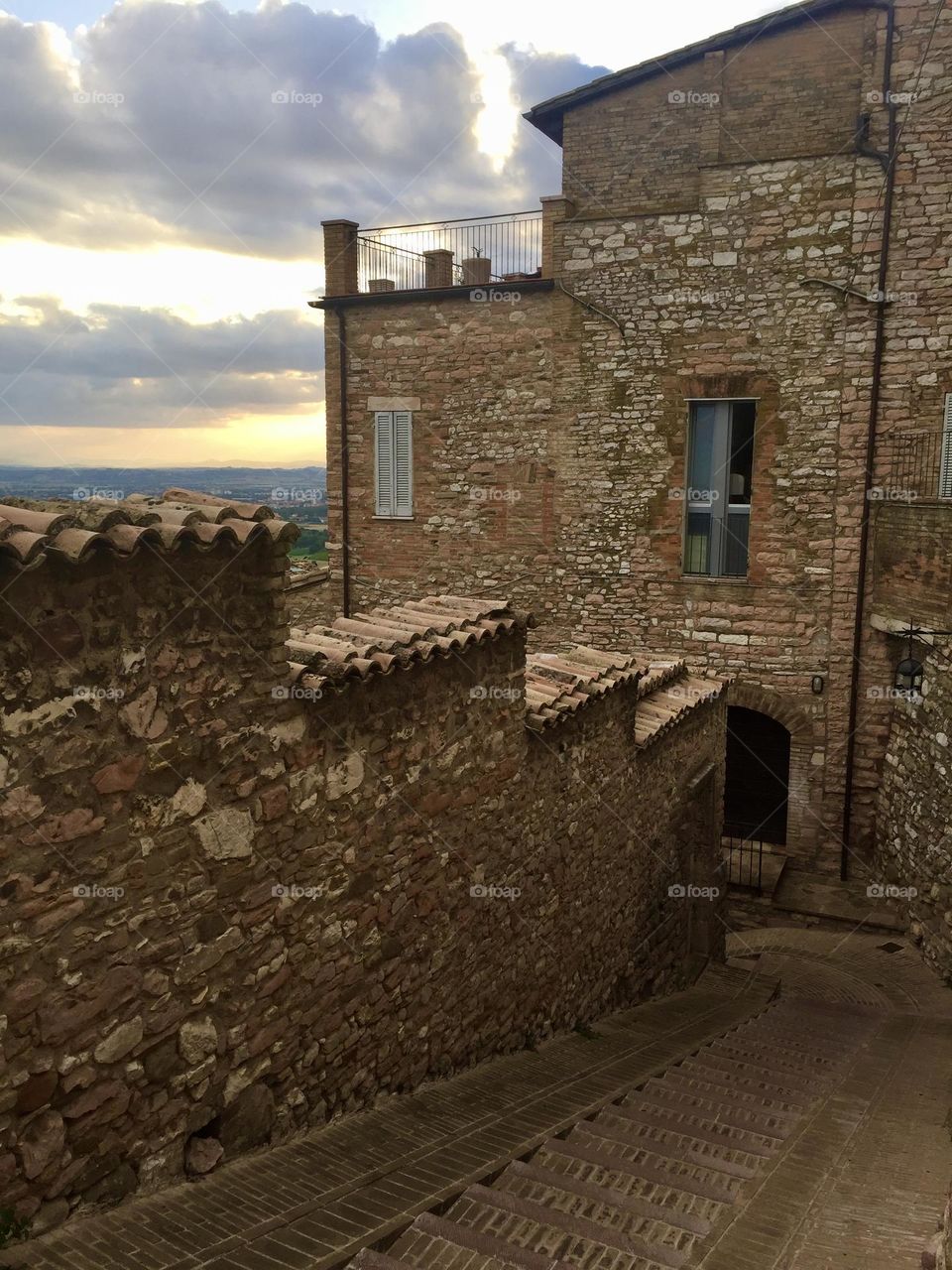 ancient houses and buildings among the streets and alleys of assisi, medieval village in Umbria, Italy 