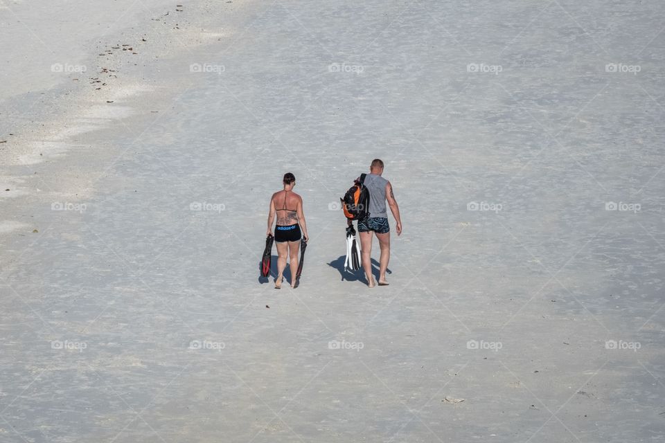 The lovers walk along the beautiful beach