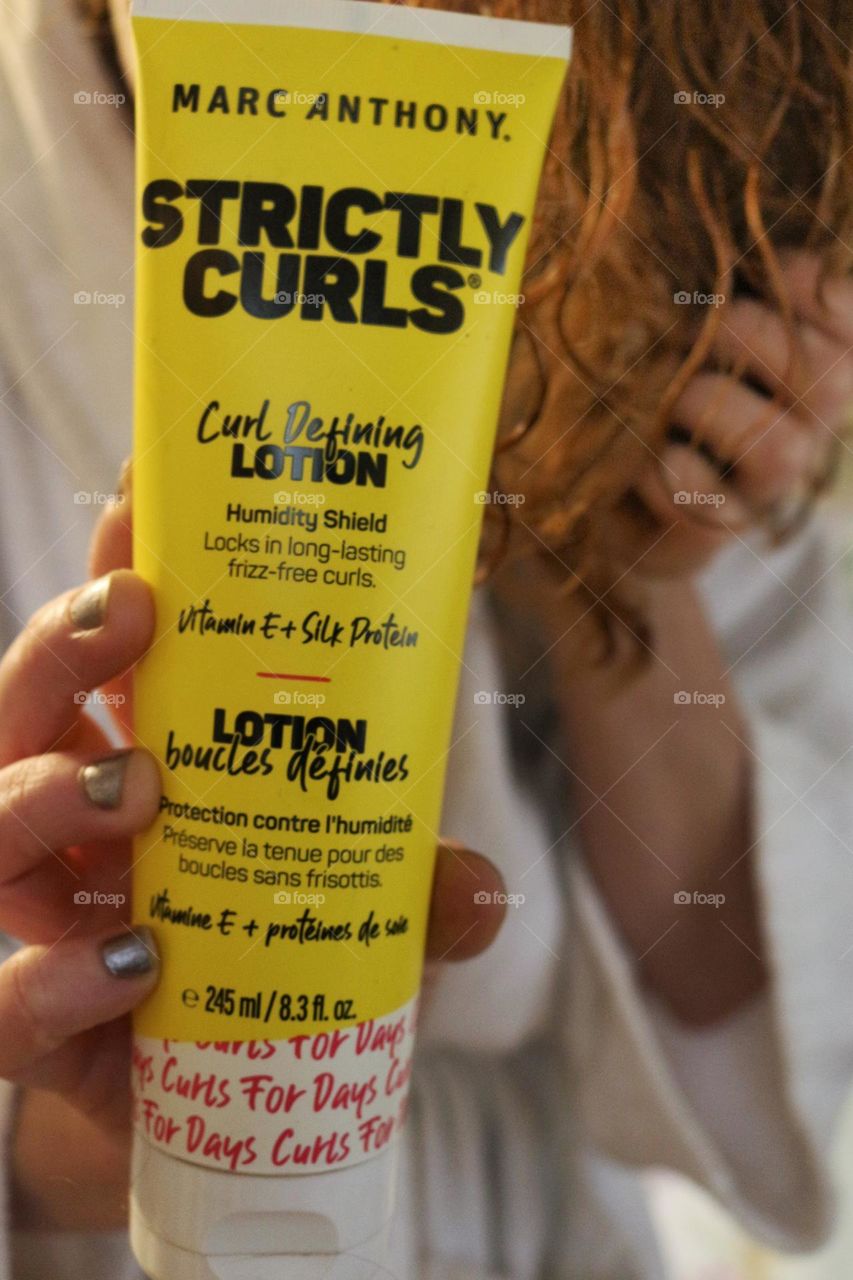 Applying Marc Anthony Strictly Curls curl defining lotion.