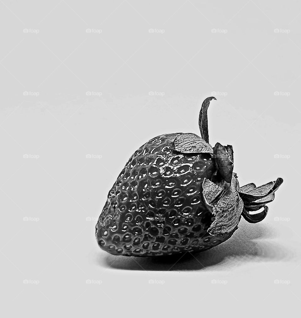 A ripe, juicy strawberry in monochrome.