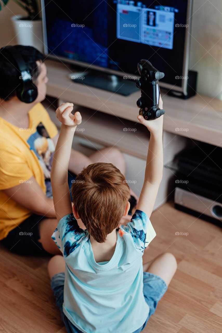 Boy and dad playing video game 