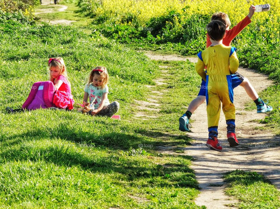 Girls Playing Quietly Snd Boys Acting Crazy In The Summer Sun
