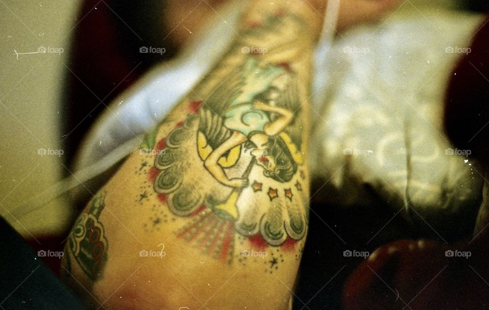 Tattoo in focus. Took this photo with my film camera. Love the grittiness to it and how it pulls your focus to the angel in his arm. 