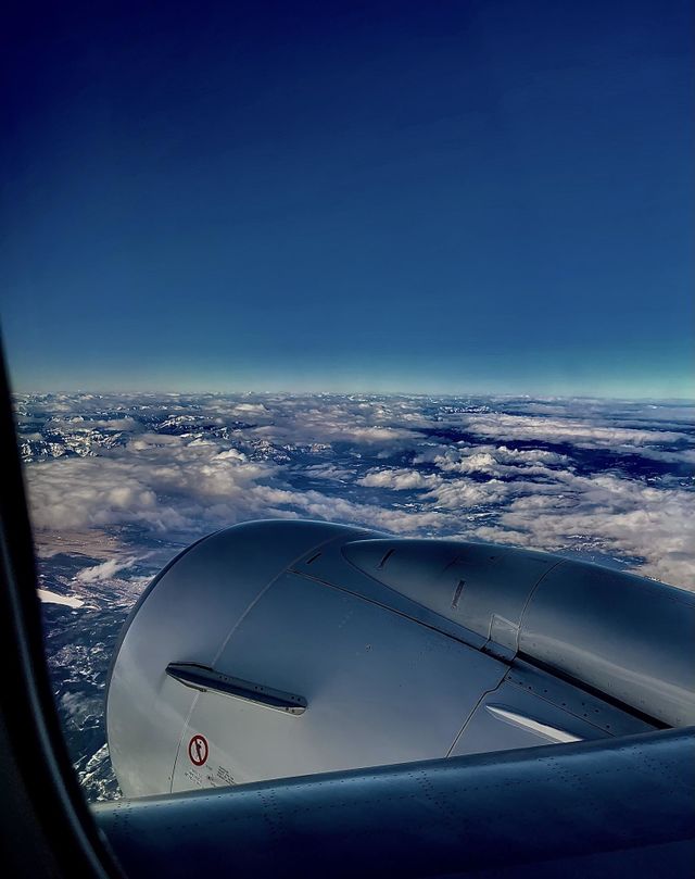 AIRPLANE WING OVER BLUE SKY