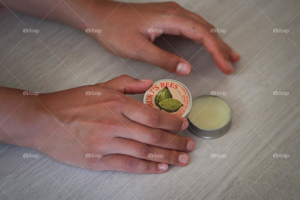 Woman's hands and Burt's bees beauty product