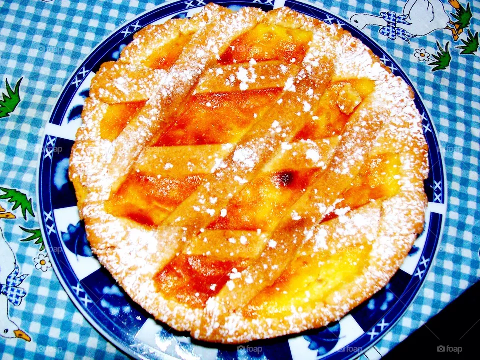 A homemade Neapolitan pastiera cake on a white and blue tablecloth