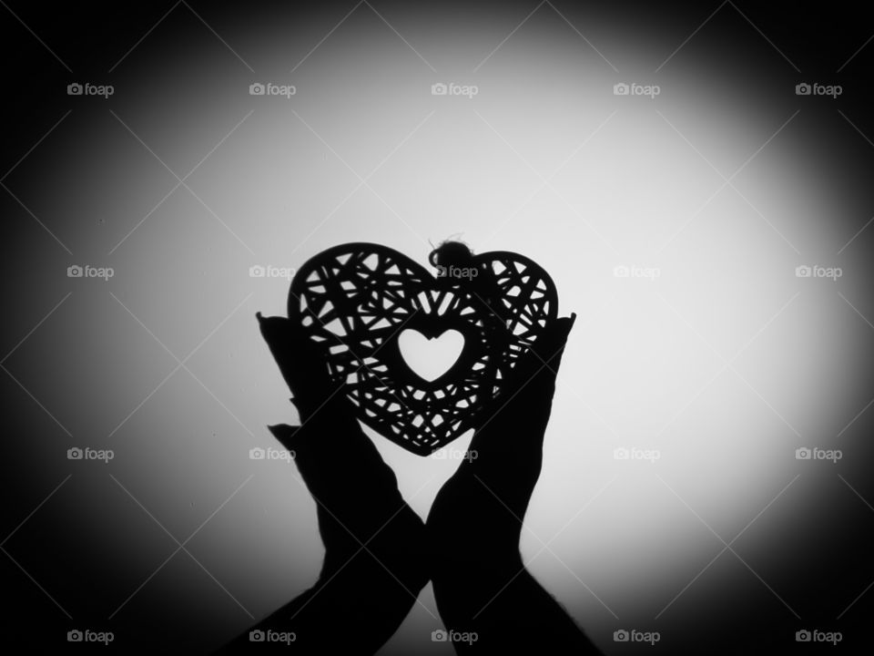 Shadow of hearth in hands.