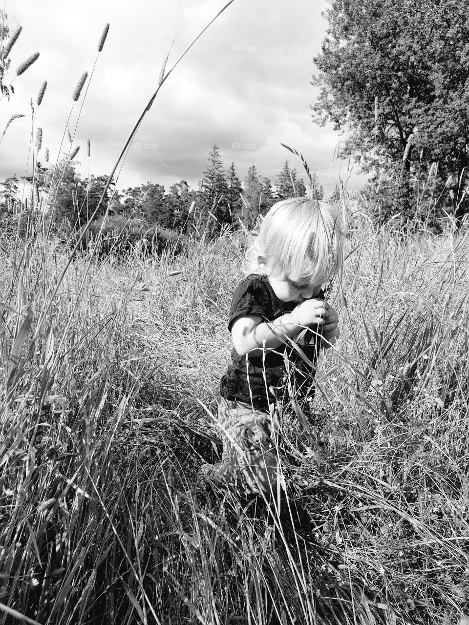 Young child enjoy swedish summer. Black and white.