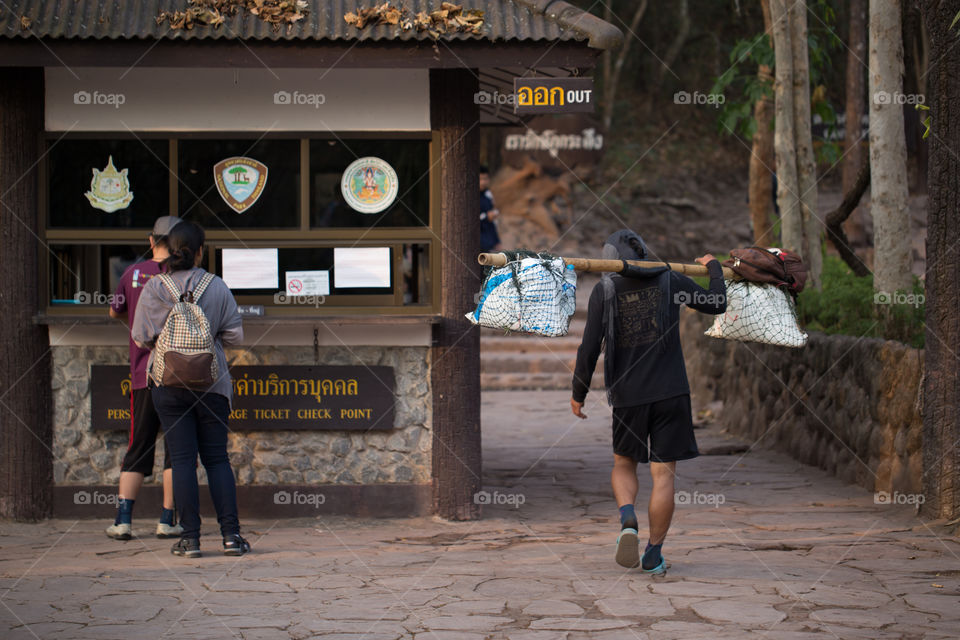 Man carry stuff on the shoulder in Phu Kradueng national park Thailand 