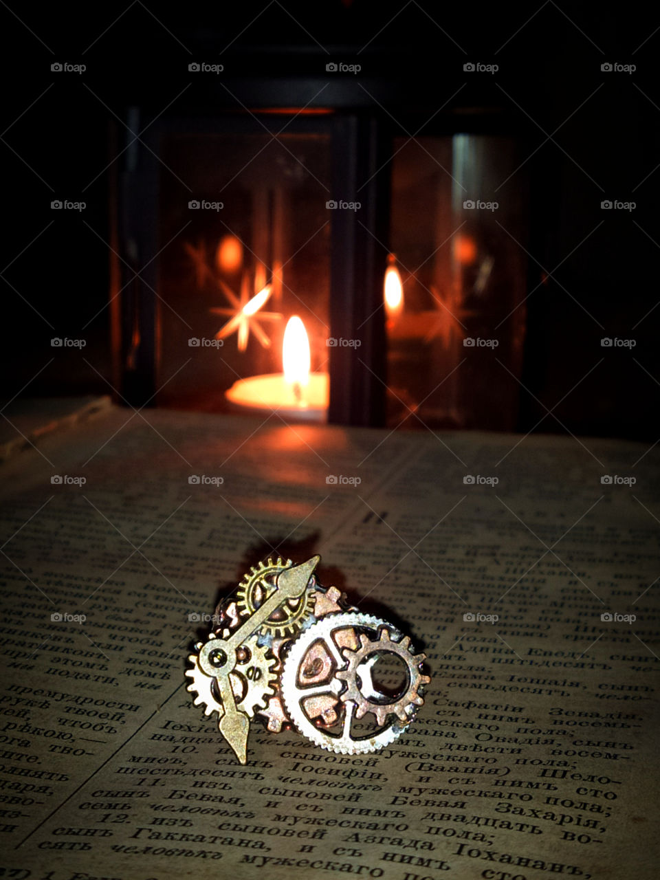 Antique Bible, luminous lantern and clockwork elements