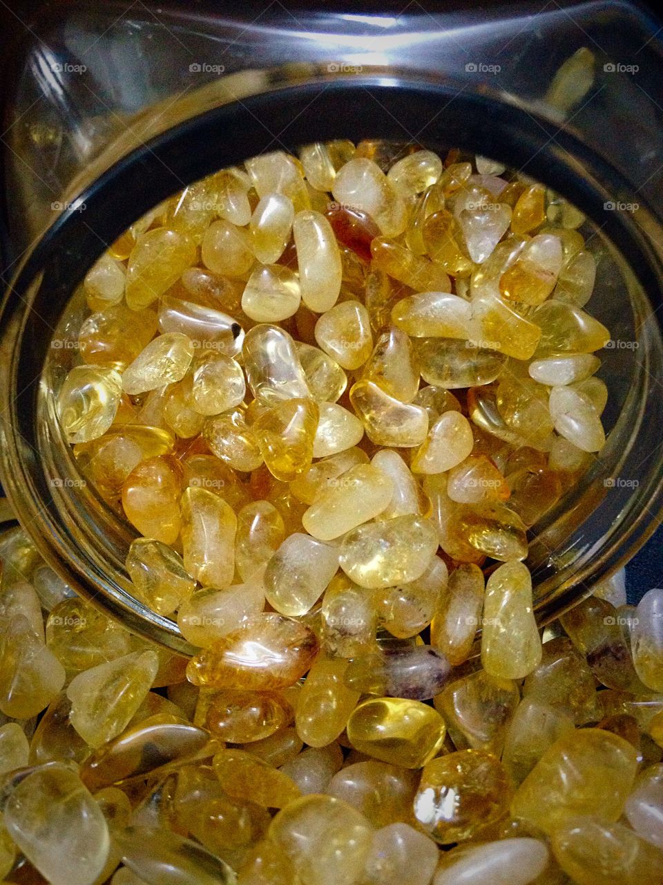 Spilt Citrine.. Polished Citrine spilling out of a glass jar.